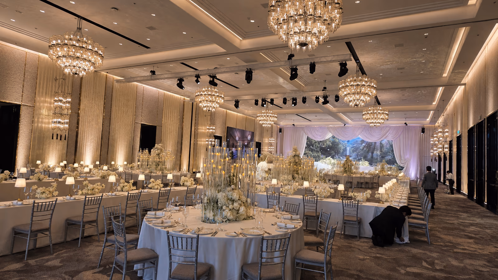 Elegant hotel banquet hall prepared for an event with warm architectural lighting